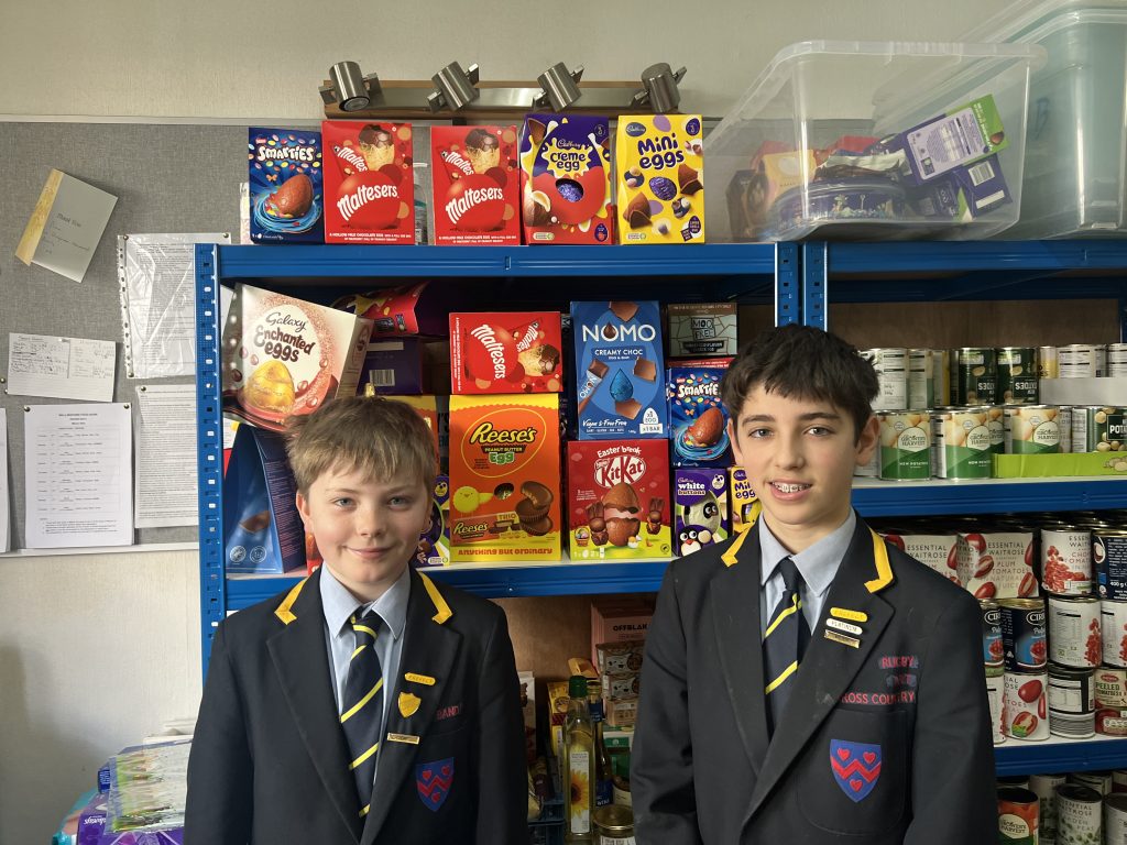 children standing in front of shelves of food