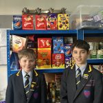 children standing in front of shelves of food