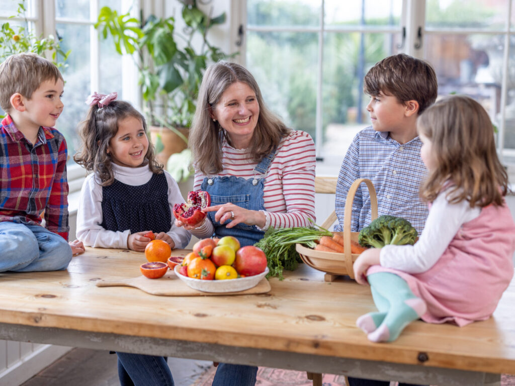 family at a table with fruits