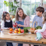 family at a table with fruits